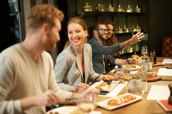 Couples eating in a nice restaurant appetizers taking a selfie