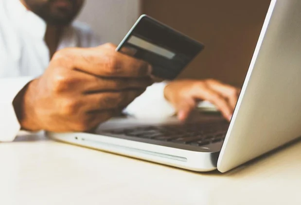 A consumer using a credit card to purchase from an e-commerce shop.